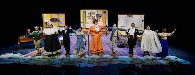 Students on stage during the performance of the Importance of Being Earnest.
