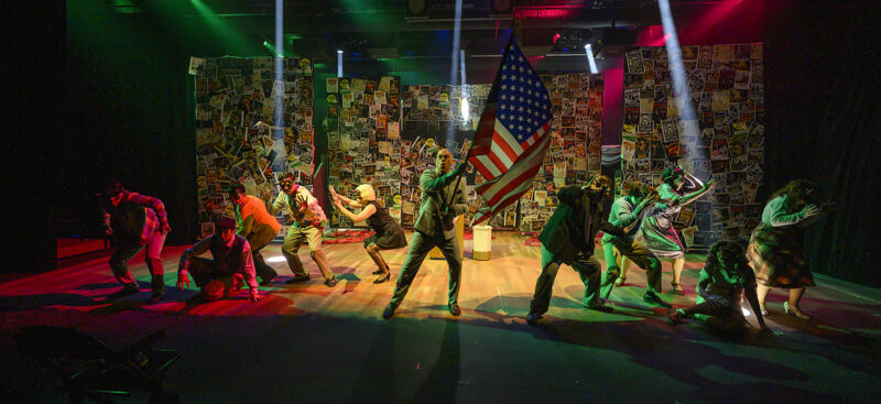 Students on stage waving a flag during the performance of Reefer Madness.