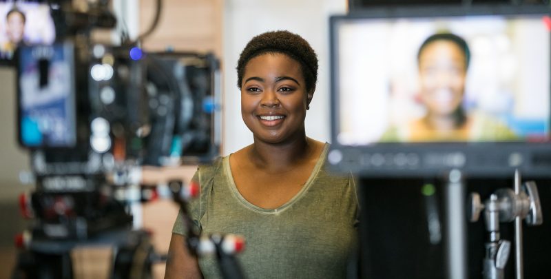 A woman standing in front of cameras