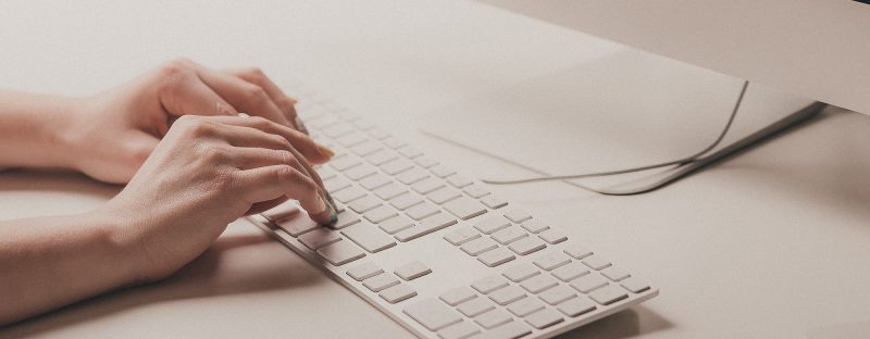 Close up of hands on a keyboard