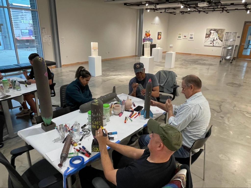 Veteran artists embellish the ceramic sculptures using acrylic markers and oil pastels.