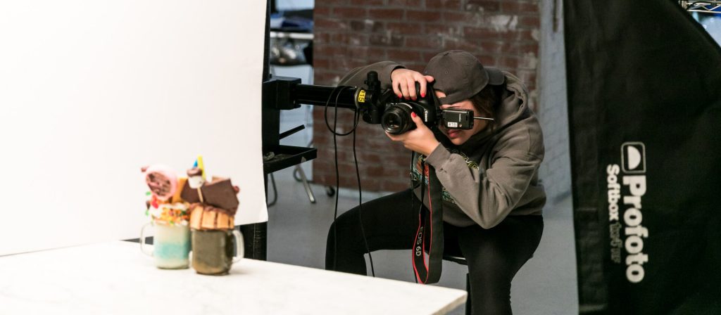 Student photographing a still life
